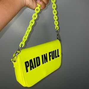 “Paid in full” neon shoulder bag.